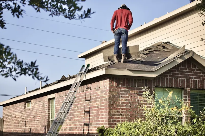 Professional roofer working on a residential roof in Spencer